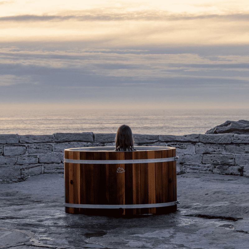 Chill Bunny Cedar Ice Bath used by woman with view