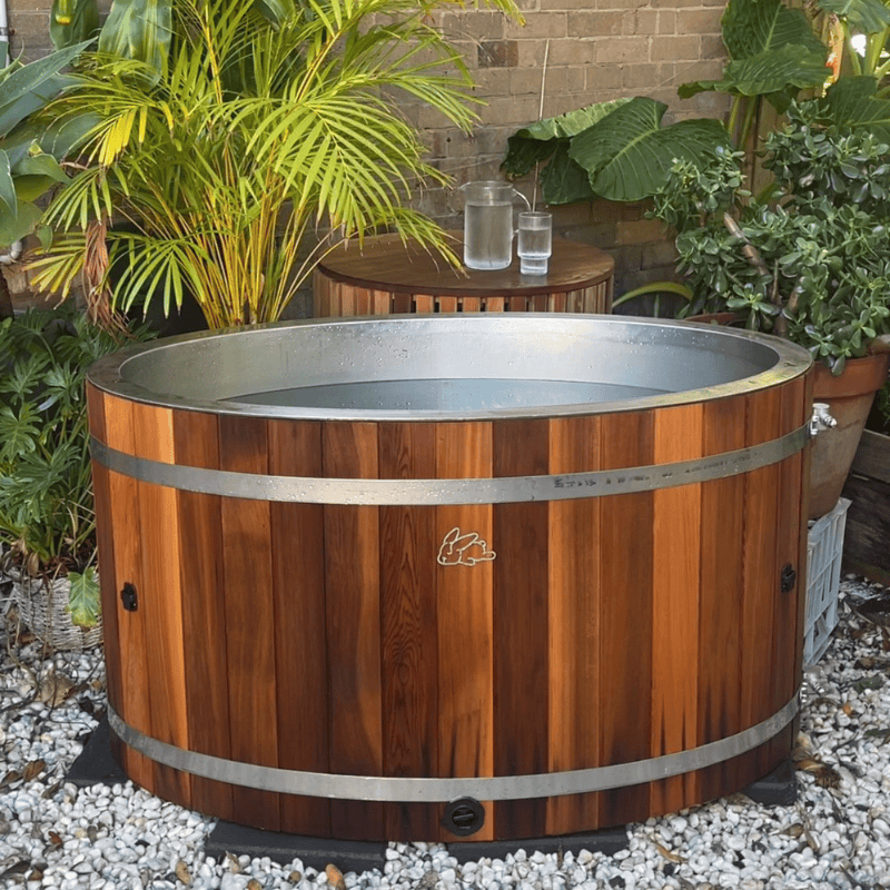 Chill Bunny Cedar Ice Bath in backyard with chiller box side table