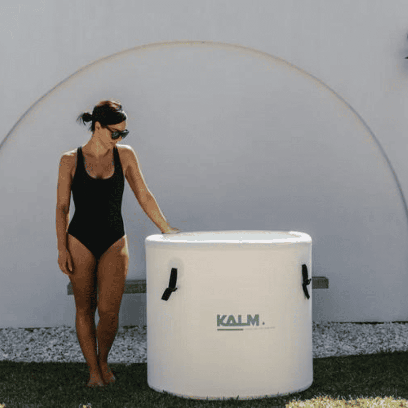 Kalm Pod Ice bath lid off with woman standing next to it