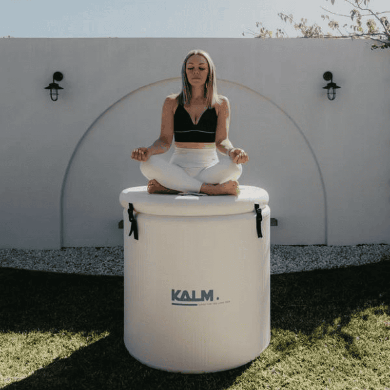 Kalm Pod Pro Ice bath with woman sitting on the lid